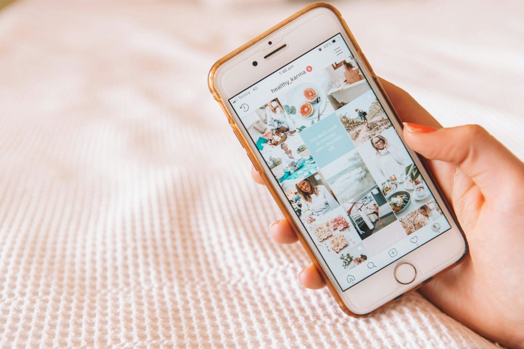 a picture of a hand holding a phone open to the Instagram app